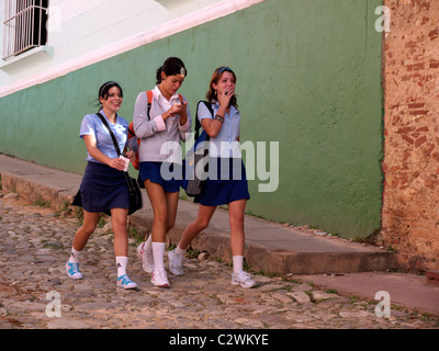 schoolgirls running through the streets of Trinidad Stock Photo