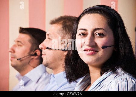 Customer support team close up ,focus on woman that smiling for you Stock Photo