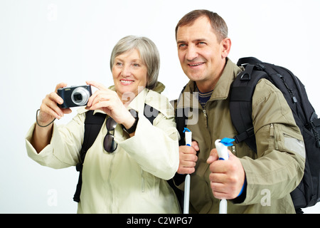 Portrait of happy senior couple going to take photo of something during trip Stock Photo