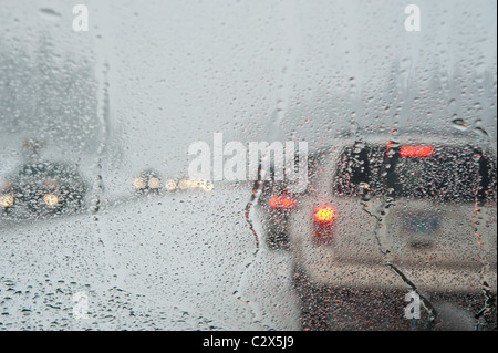 Winter traffic jam seen through a wet windshield Stock Photo