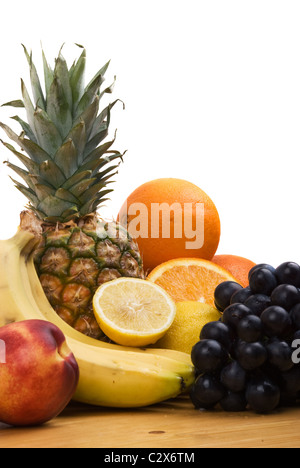 Close up of fresh fruits, whole and sliced fruit on wood table Stock Photo
