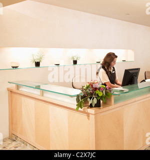 Woman working at spa resort desk Stock Photo