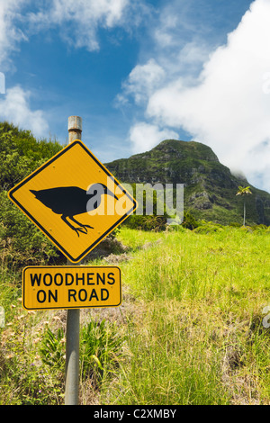 Mt Lidgbird (left) & Mt Gower & roadside warning sign for the endangered Lord Howe Woodhen on Lord Howe Island, New South Wales Stock Photo