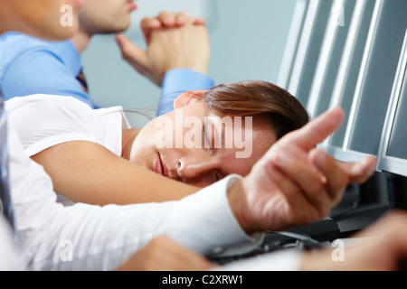 A businesswoman falling asleep on her workplace Stock Photo