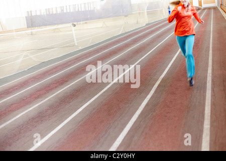 Blurred image of a girl running in gym Stock Photo