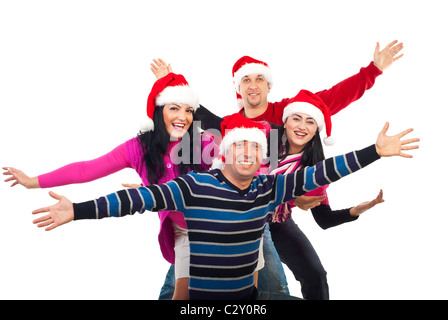 Excited group of friends wearing colorful clothes and Santa hats and standing with hands in the air laughing isolated on white Stock Photo