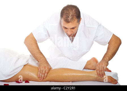 Real professional masseur massaging woman's leg with oil Stock Photo