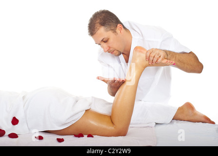 Therapist man massaging woman's leg at spa resort Stock Photo