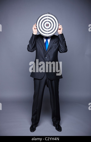 businessman hiding his face behind target Stock Photo