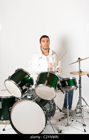 Active drummer playing at drums set in a studio Stock Photo