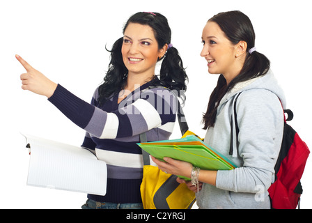 Student woman pointing away and showing something to her colleague isolated on white background Stock Photo