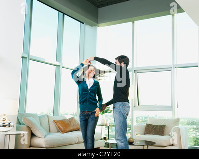 Couple dancing together in living room Stock Photo