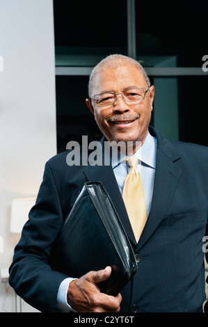 Black businessman in suit holding portfolio Stock Photo