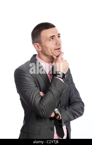 Young handsome business man looking up thoughtfully isolated on white background Stock Photo