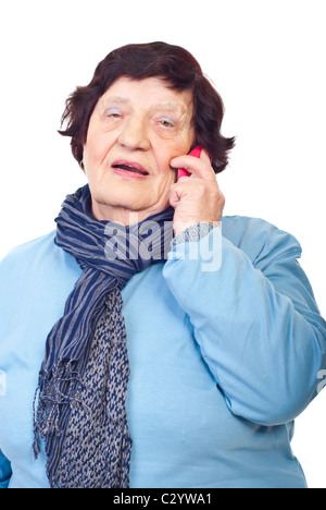 Elderly woman having conversation by phone mobile and hearing surprised news isolated on white background Stock Photo