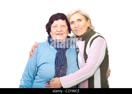 Elderly mother and senior daughter embracing and smiling isolated on white background Stock Photo