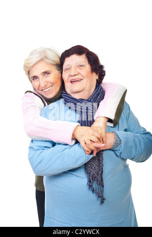 Laughing elderly mother with senior daughter embracing isolated on white background Stock Photo