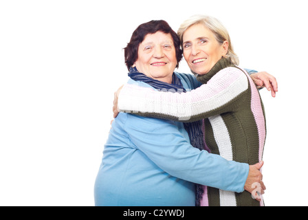 Portrait of happy elderly mother embracing senior daughter over white background,copy space for text message in left part Stock Photo