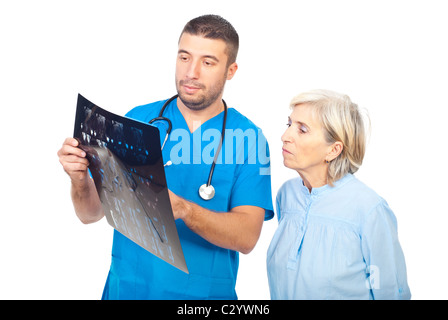 Doctor man showing and explaining his patient senior woman the MRI scans results Stock Photo