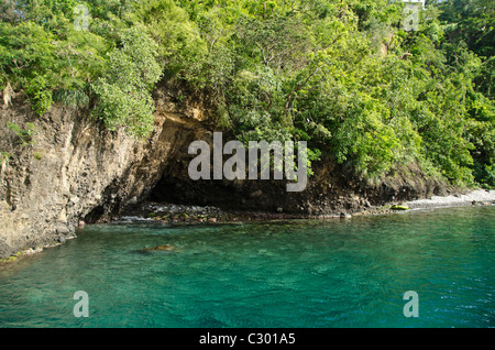 St Vincent island rocky coastline with a cave flooded by Caribbean sea Stock Photo