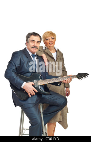 Mature business man in formal wear playing electronic guitar and being assisted by a woman isolated on white background Stock Photo