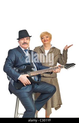 Mature elegant guitarist playing guitar and his wife smiling isolated on white background Stock Photo