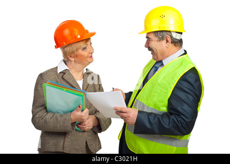 Two mature architects holding folders and contract and having a funny conversation isolated on white background Stock Photo