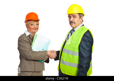 two middle aged architects shaking hands for an agreement isolated on white background Stock Photo