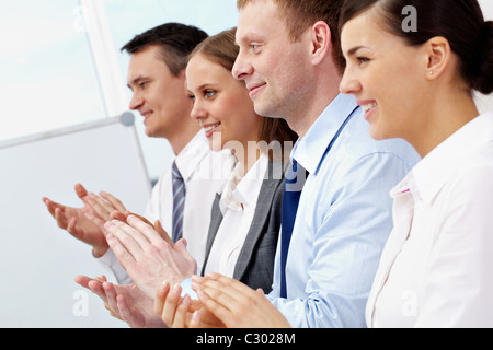 Photo of business partners applauding at meeting with focus on happy man Stock Photo