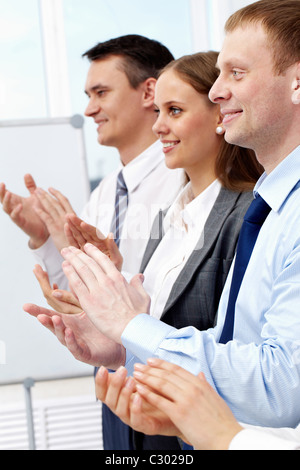 Photo of business partners applauding at meeting with happy man in front Stock Photo