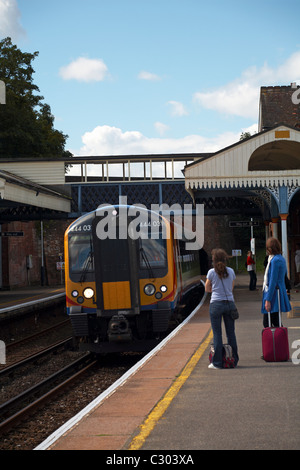 Passengers on the platform at Branksome train station, Poole, Dorset UK waiting to board the train to London in September Stock Photo