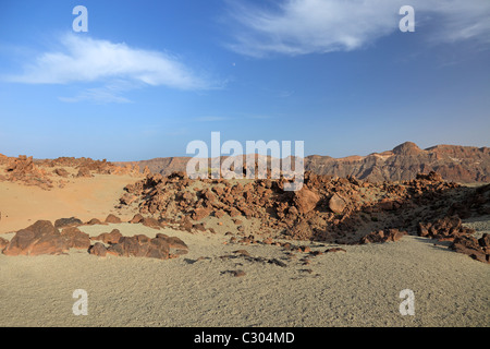 Volcanic desert at Tenerife Canary island. Blue sky, arid dry sand heat, rocky lava. Scenic geology formation landmark. Lunar landscape exploration. Stock Photo