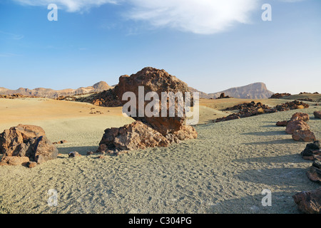 Volcanic desert at Tenerife Canary island. Blue sky, arid dry sand heat, rocky lava. Scenic geology formation landmark. Lunar landscape exploration. Stock Photo