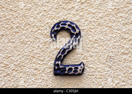 Number two made of metal on textured surface. Stock Photo