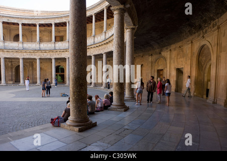 Visitors admire the inner circle of Palacio de Carlos V at Alhambra, Granada. Stock Photo