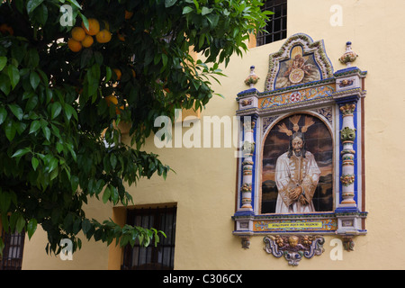 Andalucian ceramic tiling of Jesus Mary on a church wall in Seville. Stock Photo