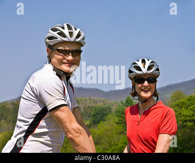 A smiling man and woman in cycling gear. Stock Photo
