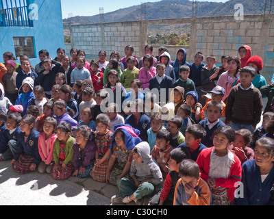School children gathered in schoolyard to visit with Habitat for Humanity Guatemala volunteers and staff. Stock Photo
