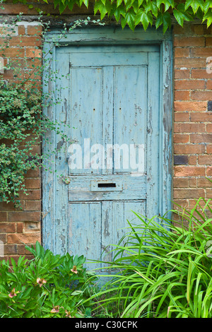 Peeling paint on a doorway in the Cotswolds village of Bledington, Oxfordshire, UK Stock Photo