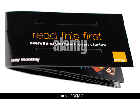 Orange mobile phone booklet titled Read this First everthing you need to get started. EDITORIAL ONLY Stock Photo