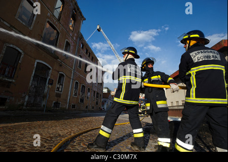 Firemen fighting urban fire Stock Photo