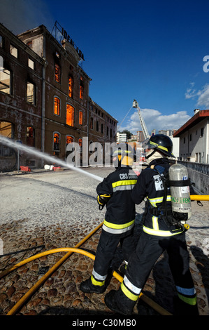 Firemen fighting urban fire Stock Photo