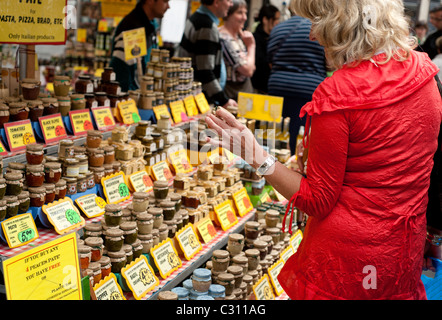 Rome, Italy - 22 April 2011 - Woman at a stand selling traditional Italian  products in jars Stock Photo