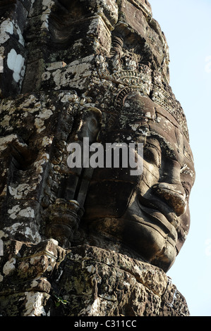 Giant stone smiling face in Bayon temple in the famous Angkor Archaeological Park Stock Photo