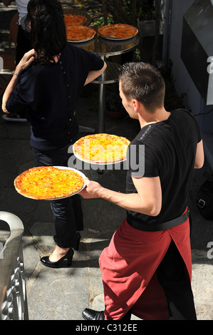 Happy dad carries serious podgy cute son. Stock Photo