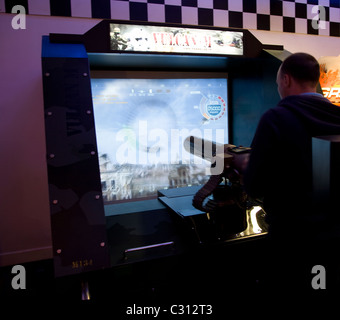 Man playing shooting game Electric Palace amusement arcade Weymouth Dorset England Stock Photo