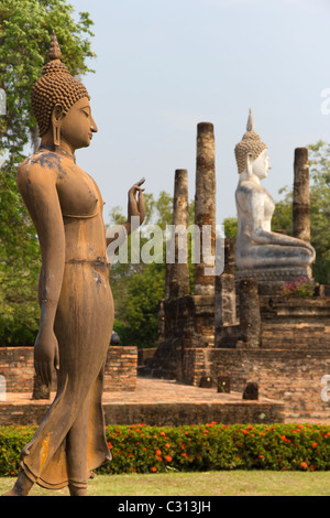 Statues of the Walking Buddha and Seated Buddha at Wat Sa Si, Part of the Sukothai Historical Park in Thailand Stock Photo