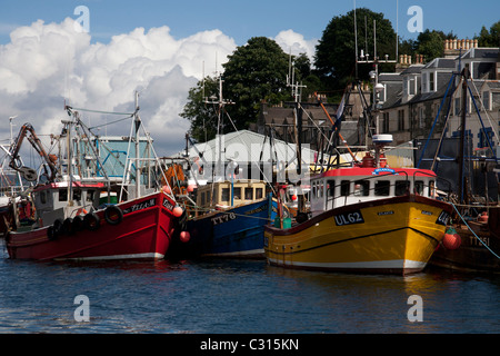 Fishing boats tied up at the dockside in the small fishing port of Tarbert, Loch Fyne. Stock Photo