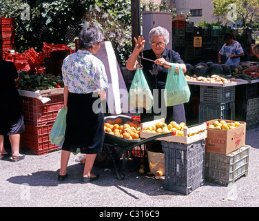Local woman selling lemons on a market stall, Albox, Near Almeria, Almeria Province, Andalucia, Spain, Western Europe. Stock Photo