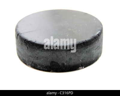 Black old hockey puck isolated on white background Stock Photo